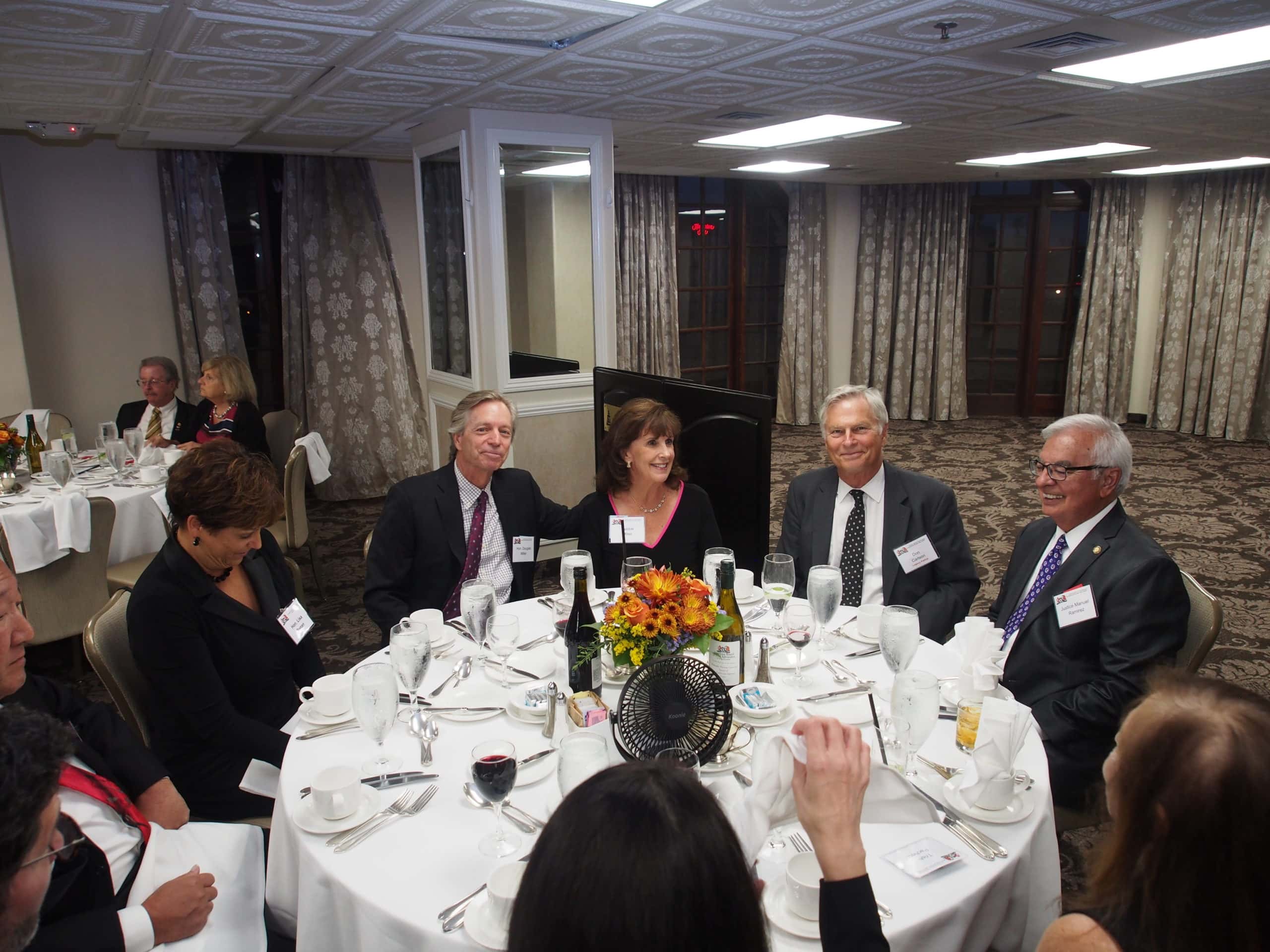 Five people sit around a table.