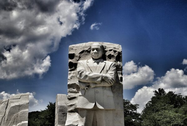 Statue memorial of Martin Luther King Jr. against blue sky with white clouds