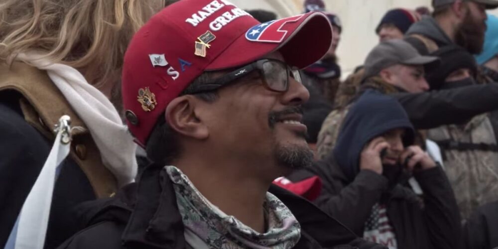 Daniel Rodriguez, in a red MAGA hat, glasses and neck coil, at the Capitol building on Jan. 6